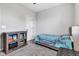 A bedroom with a tufted bed, ottoman, display shelves, and carpet at 1407 Allen Ct, Shelbyville, IN 46176