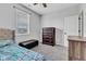 A bedroom with a tufted bed, ottoman, dresser, and ceiling fan at 1407 Allen Ct, Shelbyville, IN 46176