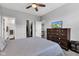 Bedroom with ceiling fan, TV, and closet in a gray carpeted room at 1407 Allen Ct, Shelbyville, IN 46176
