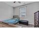 A gray carpeted bedroom with a tufted bed and plenty of natural light at 1407 Allen Ct, Shelbyville, IN 46176