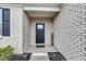 Inviting front porch with brick facade and 'Welcome' sign at 1407 Allen Ct, Shelbyville, IN 46176