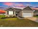 Charming brick home with a manicured lawn and two-car garage at 1407 Allen Ct, Shelbyville, IN 46176
