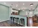 The kitchen features a breakfast bar with stylish seating, pendant lighting and a view of the front entry at 1407 Allen Ct, Shelbyville, IN 46176