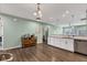 Open kitchen area with island, stainless steel appliances, and hardwood floors at 1407 Allen Ct, Shelbyville, IN 46176