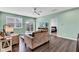 Inviting living room with modern furnishings, natural light, ceiling fan, and easy access to backyard through sliding doors at 1407 Allen Ct, Shelbyville, IN 46176