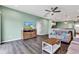 Inviting living room with hardwood floors, a TV, and a view to the modern kitchen and front entryway at 1407 Allen Ct, Shelbyville, IN 46176