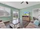 Comfortable living room with hardwood floors, a ceiling fan, and a glass sliding door to the backyard at 1407 Allen Ct, Shelbyville, IN 46176