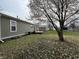 Large backyard with deck and several storage sheds and mature trees provides great outdoor space at 1424 Ashley Dr, Lebanon, IN 46052