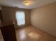 A cozy bedroom with laminate flooring and a light-filled window offers a comfortable retreat at 1424 Ashley Dr, Lebanon, IN 46052