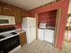 Cozy kitchen area featuring major appliances, cabinetry, and a laundry area tucked to the side at 1424 Ashley Dr, Lebanon, IN 46052