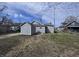 The home's rear exterior showcases gray vinyl siding with a detached shed and a spacious yard at 1445 S Belmont Ave, Indianapolis, IN 46221