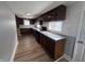 Well-lit kitchen featuring rich wood cabinets, new appliances, and white subway tile backsplash at 1445 S Belmont Ave, Indianapolis, IN 46221