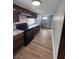 This kitchen features wood-look flooring, black appliances, and plentiful countertop space at 1445 S Belmont Ave, Indianapolis, IN 46221
