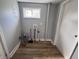A simple laundry area with wood-look floors and gray walls is ready for your machines at 1445 S Belmont Ave, Indianapolis, IN 46221
