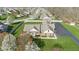 Aerial view of a charming brick home with a lush lawn and mature trees, located on a corner lot at 1484 N County Road 900 E, Avon, IN 46123