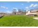 Green backyard featuring a well-manicured lawn, privacy fence, and outdoor deck with a hot tub at 1484 N County Road 900 E, Avon, IN 46123