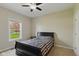 Cozy bedroom with a queen-sized bed, soft carpeting, and a bright window overlooking the front yard at 1484 N County Road 900 E, Avon, IN 46123
