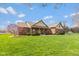 Charming brick home featuring a covered porch, mature landscaping, and a well-manicured lawn at 1484 N County Road 900 E, Avon, IN 46123