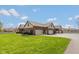 Spacious three car garage with ample parking, beautiful landscaping, and brick exterior at 1484 N County Road 900 E, Avon, IN 46123