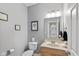 A stylish half bathroom with a clean design, modern fixtures, and tasteful wall art at 1484 N County Road 900 E, Avon, IN 46123