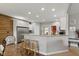 Open kitchen featuring a breakfast bar with granite counters, stainless appliances, and hardwood floors at 1484 N County Road 900 E, Avon, IN 46123