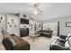 Spacious living room with a fireplace, built-in shelving and comfortable black leather seating at 1484 N County Road 900 E, Avon, IN 46123