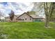 Exterior view of the back of the home with brick and siding on a large green lawn at 1509 Copperwood Pl, Carmel, IN 46033