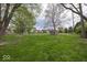 Spacious backyard with lush lawn, trees, and an outbuilding shed at the rear at 1509 Copperwood Pl, Carmel, IN 46033