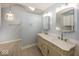 Updated bathroom featuring dual sinks, marble countertops, and modern lighting at 1509 Copperwood Pl, Carmel, IN 46033