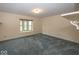 Neutral bedroom with a window overlooking a grassy front yard and wall to wall blue carpeting at 1509 Copperwood Pl, Carmel, IN 46033