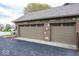 Attached two car garage with brick facade and decorated windows at 1509 Copperwood Pl, Carmel, IN 46033