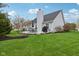 Spacious backyard with a well-manicured lawn, a patio with furniture, and mature trees at 15129 Smithfield Dr, Westfield, IN 46074