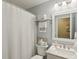 Well-lit bathroom with a shower featuring white tile, a vanity with marble countertop, and organized towel storage at 15129 Smithfield Dr, Westfield, IN 46074