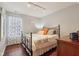 Cozy bedroom featuring a wrought iron bed frame and abundant natural light from a window with decorative curtains at 15129 Smithfield Dr, Westfield, IN 46074