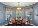 Bright dining area with large windows, a chandelier, and a hardwood floors at 15129 Smithfield Dr, Westfield, IN 46074