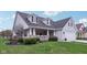 A charming home showcasing a cozy front porch, well-maintained landscaping, and beautiful curb appeal at 15129 Smithfield Dr, Westfield, IN 46074