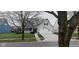 Attractive home with blooming trees framing the well-kept yard and two-car garage at 15129 Smithfield Dr, Westfield, IN 46074