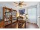 Inviting home office with hardwood floors, built-in bookshelves, and a ceiling fan for added comfort at 15129 Smithfield Dr, Westfield, IN 46074