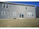 Back exterior of home featuring gray siding, windows, and a sliding glass door at 15365 Todd S Ln, Fishers, IN 46037