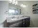 Well-lit bathroom featuring double sink vanity with granite countertop and tile backsplash at 15365 Todd S Ln, Fishers, IN 46037