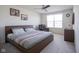 Inviting bedroom features a queen-sized bed, ceiling fan, and a cozy reading chair at 15365 Todd S Ln, Fishers, IN 46037