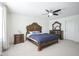 Carpeted bedroom features a ceiling fan and traditional bedroom furniture at 15365 Todd S Ln, Fishers, IN 46037