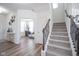 Bright entryway features hardwood floors, stairs, and an open living space, creating an inviting welcome at 15365 Todd S Ln, Fishers, IN 46037