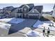 Aerial view of a two-story home with brick and siding, a two-car garage, and a snowy front yard at 15365 Todd S Ln, Fishers, IN 46037