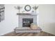 Close up of a stone fireplace with wooden mantel and decorative accents at 15365 Todd S Ln, Fishers, IN 46037
