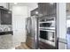 Modern kitchen featuring stainless steel appliances, granite counters, and dark wood cabinets at 15365 Todd S Ln, Fishers, IN 46037