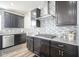 Updated kitchen with stainless steel appliances, granite countertops, and sleek dark cabinetry at 15365 Todd S Ln, Fishers, IN 46037