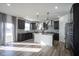Stylish kitchen featuring dark cabinets, a center island, and stainless steel appliances at 15365 Todd S Ln, Fishers, IN 46037
