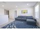 Comfortable living room with a large sectional couch, neutral carpet, and bright natural light at 15365 Todd S Ln, Fishers, IN 46037