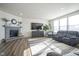 Inviting living room featuring a stone fireplace, comfortable seating, and large windows at 15365 Todd S Ln, Fishers, IN 46037